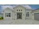 Gray two-story house with stone accents and double front doors at 16026 39Th E Gln, Parrish, FL 34219