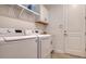 Laundry room with washer, dryer, cabinets and shelving at 16026 39Th E Gln, Parrish, FL 34219