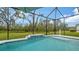 Refreshing screened pool with fountain and lush landscaping at 16026 39Th E Gln, Parrish, FL 34219