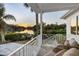 Covered patio features seating area with tranquil water views and sunset at 1718 Bay St, Sarasota, FL 34236