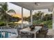 Relaxing patio with outdoor dining set overlooking the canal at sunset at 1718 Bay St, Sarasota, FL 34236