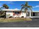 White single story home with carport and palm trees at 1741 Caribbean Cir # 13, Venice, FL 34293