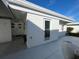 Rear view of home showing patio and door at 1741 Caribbean Cir # 13, Venice, FL 34293