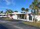 Front view of condo building showcasing carport and landscaping at 1741 Caribbean Cir # 13, Venice, FL 34293