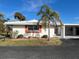 White single story home with carport and palm trees at 1741 Caribbean Cir # 13, Venice, FL 34293