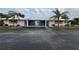 Front view of a light-colored home with carport and palm trees at 1741 Caribbean Cir # 13, Venice, FL 34293