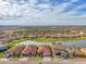 Aerial view of a house in a community by a lake at 20717 Benissimo Dr, Venice, FL 34293