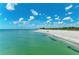 Aerial view of beach with clear water, white sand, and blue skies at 20717 Benissimo Dr, Venice, FL 34293