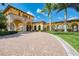 Elegant community entrance with arched walkways and manicured landscaping at 20717 Benissimo Dr, Venice, FL 34293