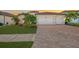 Two-story home with a large driveway and landscaped front yard at 20717 Benissimo Dr, Venice, FL 34293