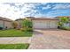 Beautiful home exterior with two-car garage and landscaping at 20717 Benissimo Dr, Venice, FL 34293