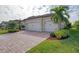 Beautiful 3-car garage home with paver driveway and nicely landscaped lawn at 20717 Benissimo Dr, Venice, FL 34293