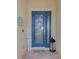 Home's entrance with a blue door, wreath, and lantern at 20717 Benissimo Dr, Venice, FL 34293