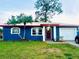 Newly painted blue home with red trim, a red door, and a white garage door at 2306 6Th Avenue E Dr, Bradenton, FL 34208