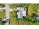 Aerial view of a single-story house with a gray roof, surrounded by lush green trees at 2669 Prospect St, Sarasota, FL 34239