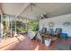 Relaxing screened porch with wicker furniture, creating a cozy outdoor sitting area at 2669 Prospect St, Sarasota, FL 34239