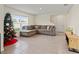 Bright living room featuring a sectional sofa and tile floors at 3284 Silver Date Dr, Wimauma, FL 33598