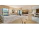 Main bedroom with a view of the patio and sitting area at 4410 Weybridge # 91, Sarasota, FL 34235