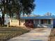 Cute ranch home with gray exterior, landscaping, and driveway at 4951 Bell Meade Dr, Sarasota, FL 34232