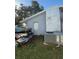 House exterior with AC unit and overgrown landscaping at 4951 Bell Meade Dr, Sarasota, FL 34232