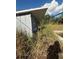 Gray storage shed in overgrown area at 4951 Bell Meade Dr, Sarasota, FL 34232