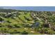 Aerial view of a lush golf course; fairways, greens, water features, and surrounding neighborhood at 7812 20Th W Pl, Bradenton, FL 34209