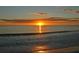 Stunning sunset over the ocean; tranquil beach with gentle waves and golden light at 7812 20Th W Pl, Bradenton, FL 34209