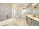 Spa-like bathroom with marble finishes, walk-in shower, and soaking tub at 7904 20Th W Pl, Bradenton, FL 34209