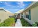 Inviting entryway with a charming gate and landscaped walkway at 805 Harrington Lake N Dr # 76, Venice, FL 34293