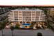 Stunning beachfront condo building with private balconies, a pool, and beautiful landscaping at 1035 Seaside Dr # 305, Sarasota, FL 34242