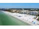 Scenic aerial view of a beachside condo with amenities and ocean access with lush tropical landscaping at 1035 Seaside Dr # 305, Sarasota, FL 34242