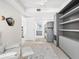 This room features a bunk bed, a comfortable chair, and view into a well-appointed bathroom, perfect for relaxing or welcoming guests at 1035 Seaside Dr # 305, Sarasota, FL 34242