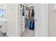 Spacious walk-in closet with built-in shelving, drawers, and hanging rods to efficiently organize clothes and accessories at 1035 Seaside Dr # 305, Sarasota, FL 34242