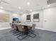Modern conference room with a large table, comfortable chairs, and contemporary artwork at 1035 Seaside Dr # 305, Sarasota, FL 34242