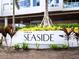 Landscaped exterior view of TEN35 Seaside, featuring modern architecture and lush greenery at 1035 Seaside Dr # 305, Sarasota, FL 34242