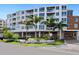Modern building with sign that reads TENERIFE SEASIDE and lush landscaping for a tranquil and luxurious feel at 1035 Seaside Dr # 305, Sarasota, FL 34242