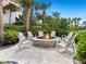 Outdoor fire pit with comfortable seating surrounded by lush landscaping at 1035 Seaside Dr # 305, Sarasota, FL 34242
