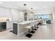 Bright, open-concept kitchen featuring a large island with seating and modern appliances at 1035 Seaside Dr # 305, Sarasota, FL 34242