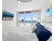 Bright bedroom boasts ocean views from a large window, a comfortable bed, and a wall-mounted television for relaxation at 1035 Seaside Dr # 305, Sarasota, FL 34242