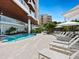 Beautiful pool area with lounge chairs, umbrellas, and well-manicured landscaping at 1035 Seaside Dr # 305, Sarasota, FL 34242