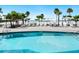 Inviting outdoor pool area with lounge chairs and a picturesque beach view at 1035 Seaside Dr # 305, Sarasota, FL 34242