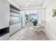 This sitting area features a comfortable lounge chair, sliding doors, and beachfront views at 1035 Seaside Dr # 305, Sarasota, FL 34242