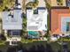 Aerial view of house and canal with tropical landscaping and boats at 322 Avenida De Paradisio, Sarasota, FL 34242