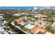 Wide aerial showing neighborhood, waterfront homes, and ocean at 322 Avenida De Paradisio, Sarasota, FL 34242