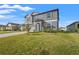 Two-story house with gray siding, teal shutters, and a two-car garage at 4016 86Th E St, Palmetto, FL 34221