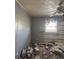 Bedroom under renovation, showing exposed walls and debris at 406 Laurel E Rd, Nokomis, FL 34275