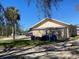 Tan colored building with attached garage and separate shed at 406 Laurel E Rd, Nokomis, FL 34275