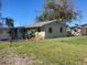 Tan single story home with grassy yard at 406 Laurel E Rd, Nokomis, FL 34275