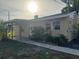 House exterior featuring a covered porch and well-maintained landscaping at 406 Laurel E Rd, Nokomis, FL 34275