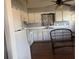 Cozy kitchen with white cabinets and laminate flooring at 406 Laurel E Rd, Nokomis, FL 34275